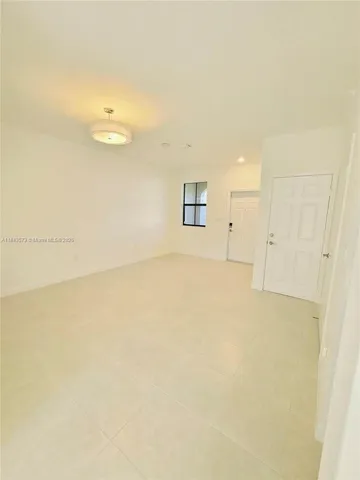 a view of a big room with a refrigerator