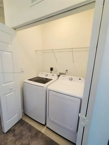 a large white kitchen with cabinets stove and sink