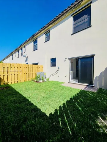 a view of yard with wooden fence