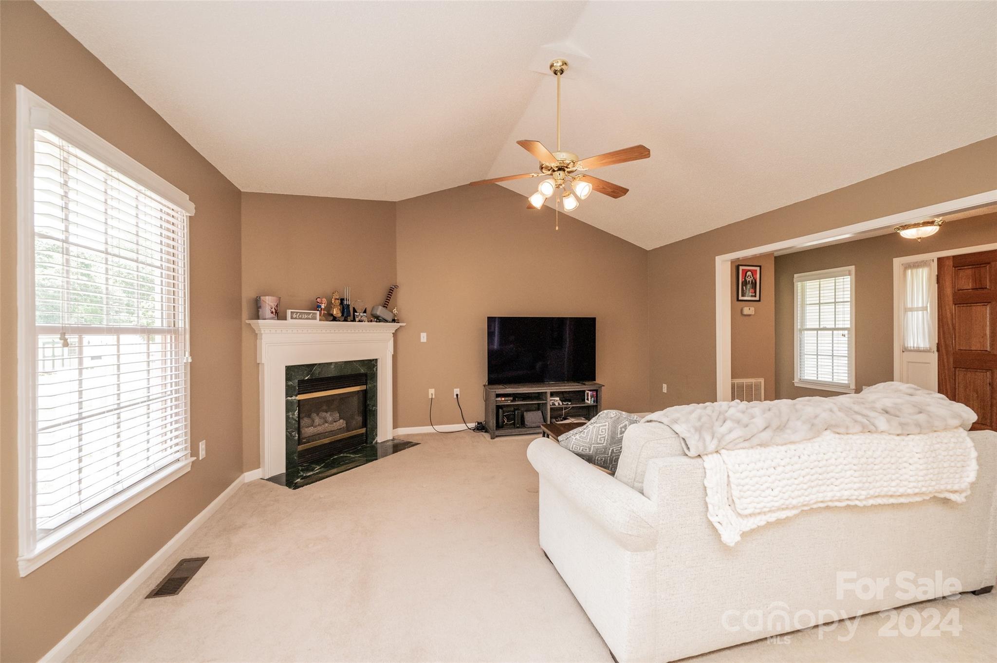 3811 River Road Hickory, NC 28602 - Photo 8 of 46 a living room with furniture a fireplace and a flat screen tv