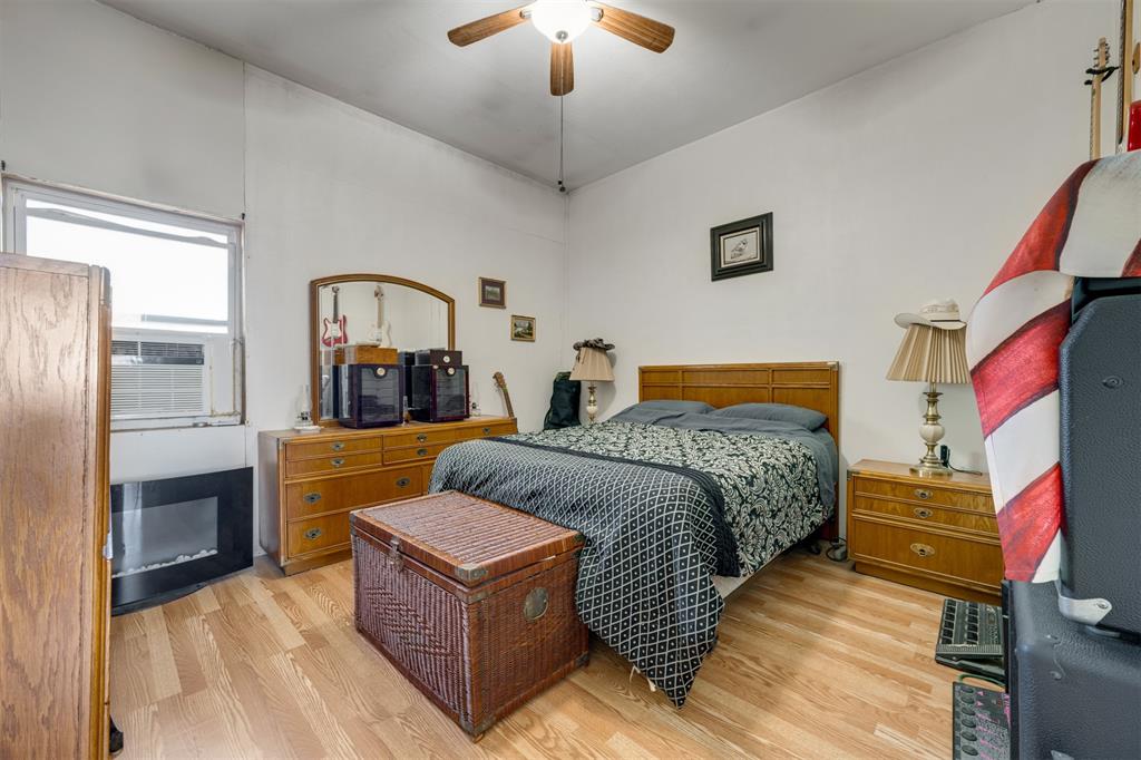 1900 County Road 33900 Powderly, TX 75473 - Photo 27 of 40 a bedroom with a bed couch and a fireplace