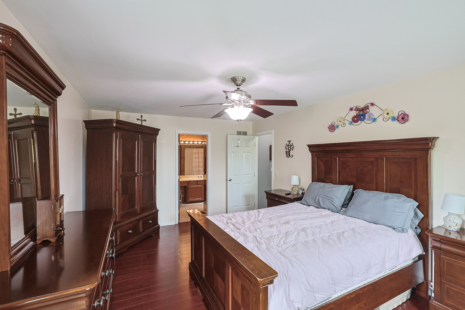 830 Hawk Lane Carol Stream, IL 60188 - Photo 15 of 30 a bedroom with a large bed and a chandelier