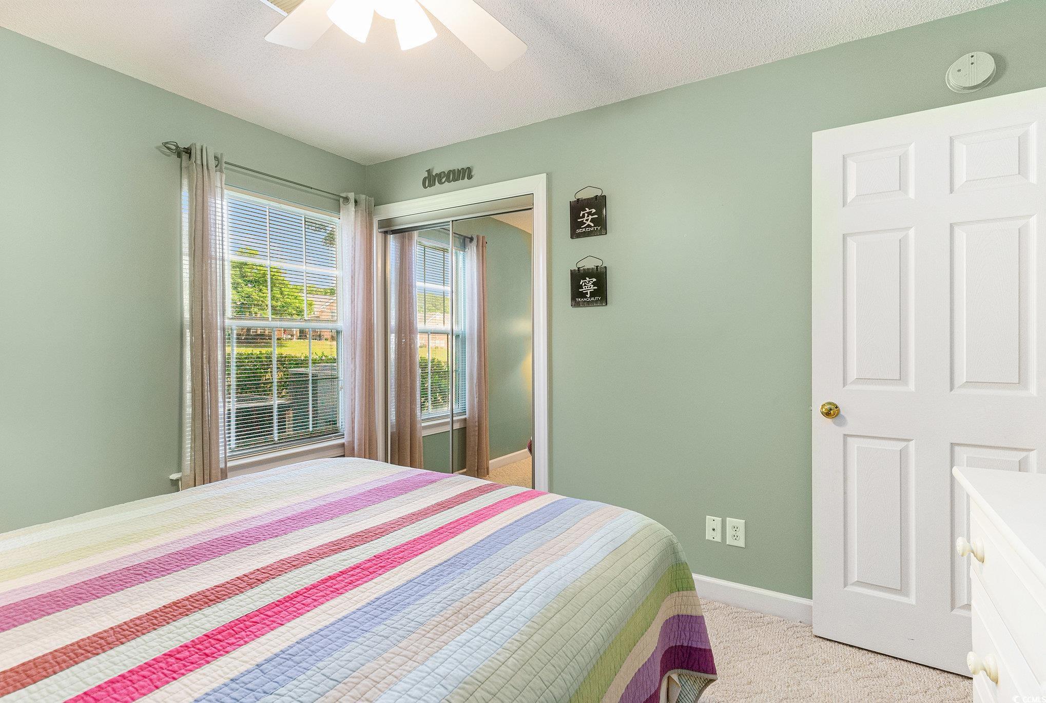 4280 Santolina Way, Unit C Murrells Inlet, SC 29576 - Photo 15 of 40 Bedroom featuring light carpet, a closet, baseboards, and ceiling fan