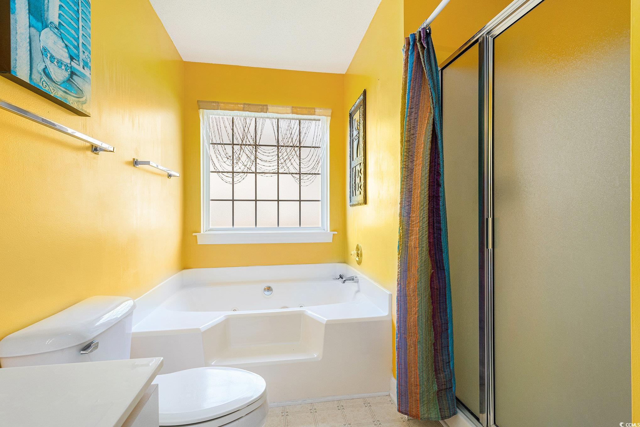 4280 Santolina Way, Unit C Murrells Inlet, SC 29576 - Photo 25 of 40 Full bathroom featuring a bath, toilet, a shower stall, vanity, and tile patterned floors