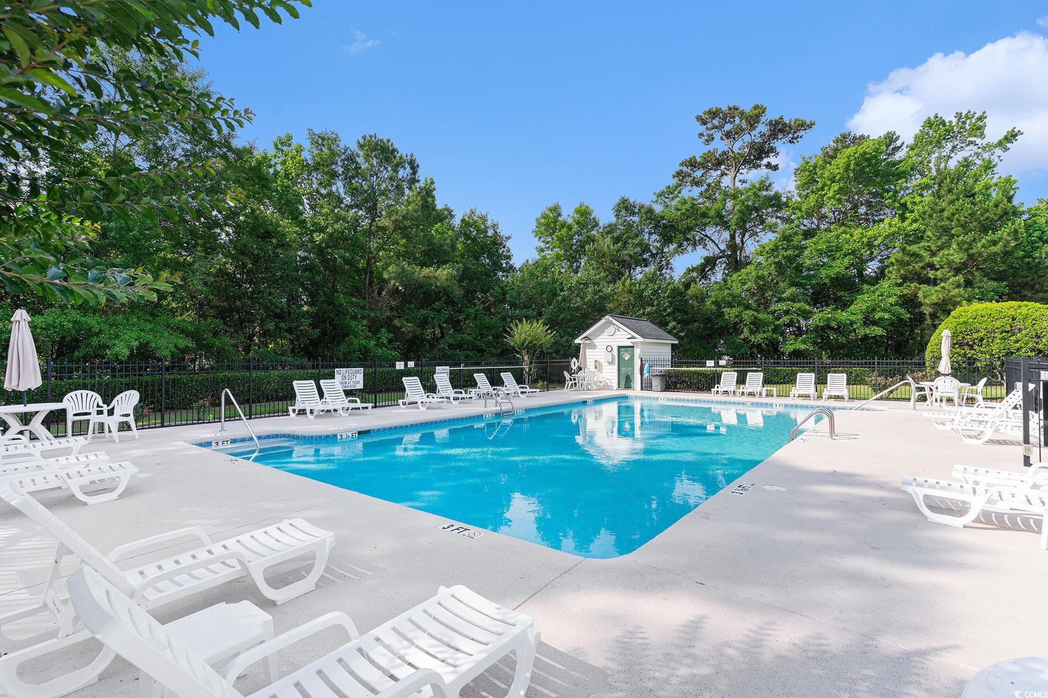 4280 Santolina Way, Unit C Murrells Inlet, SC 29576 - Photo 30 of 40 Community pool featuring a patio area and view of wooded area