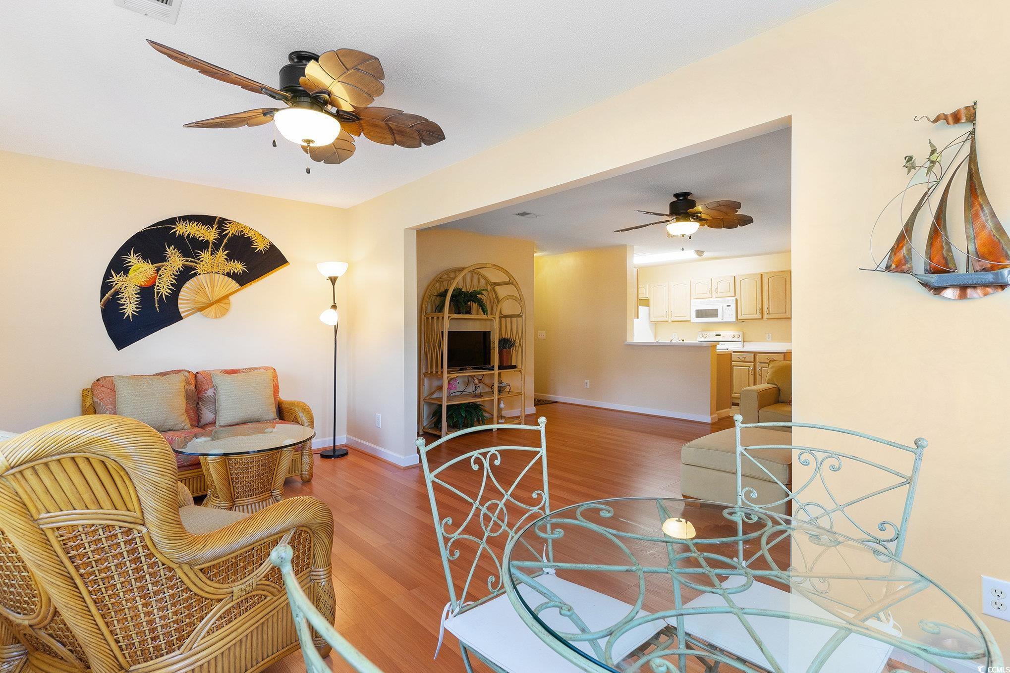 4280 Santolina Way, Unit C Murrells Inlet, SC 29576 - Photo 5 of 40 Dining space with a ceiling fan, light wood finished floors, and baseboards