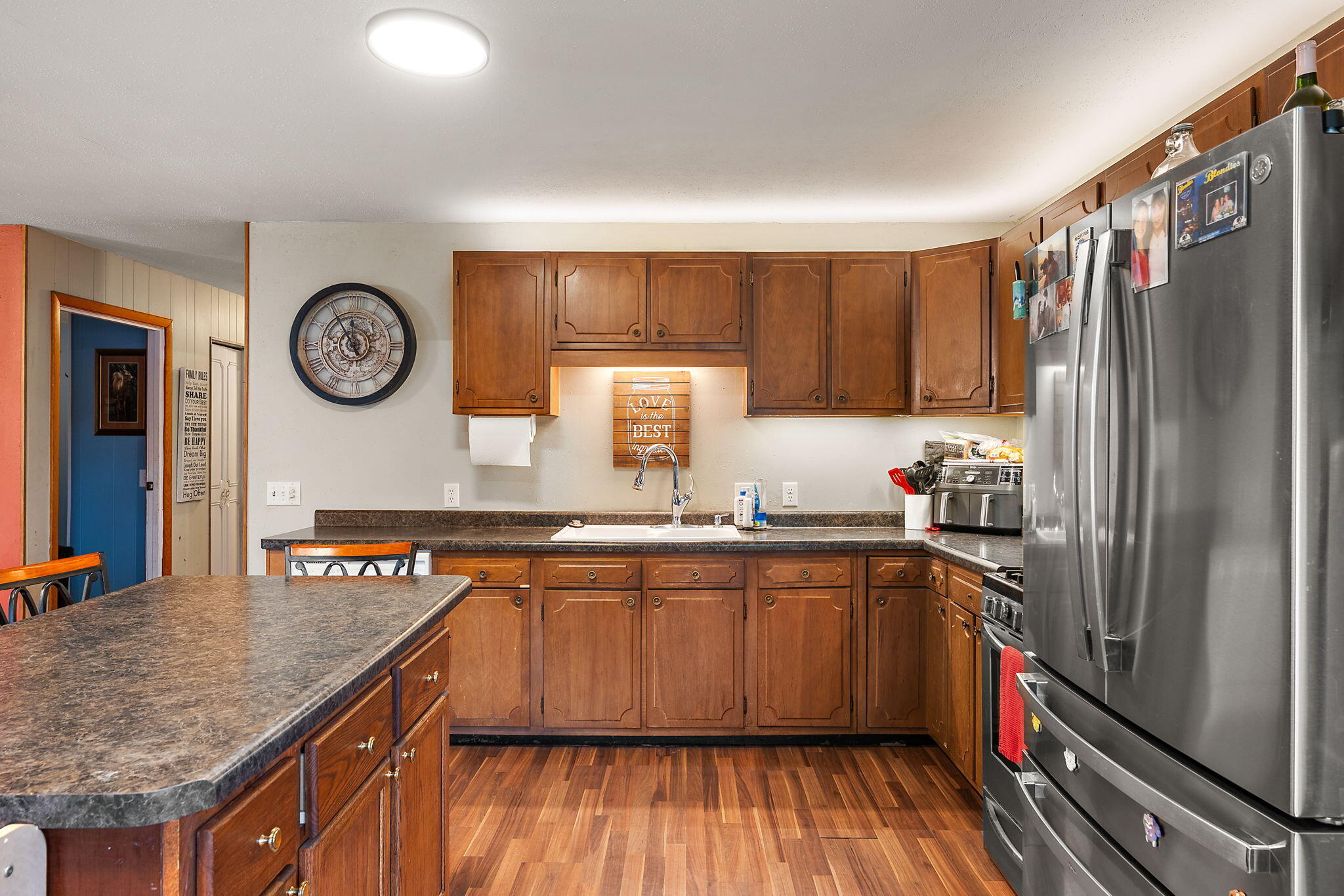 208 Stevenson Street Morocco, IN 47963 - Photo 15 of 31 a kitchen with stainless steel appliances granite countertop a stove a sink dishwasher and cabinets with wooden floor