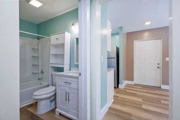 a bathroom with a toilet a shower and a sink