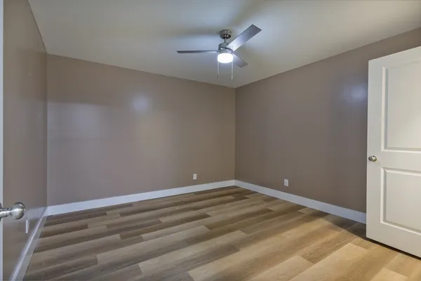 a view of room with window and ceiling fan