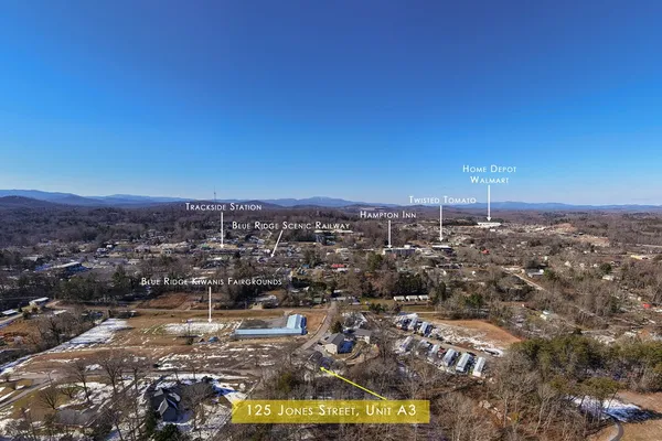 an aerial view of residential houses with city view