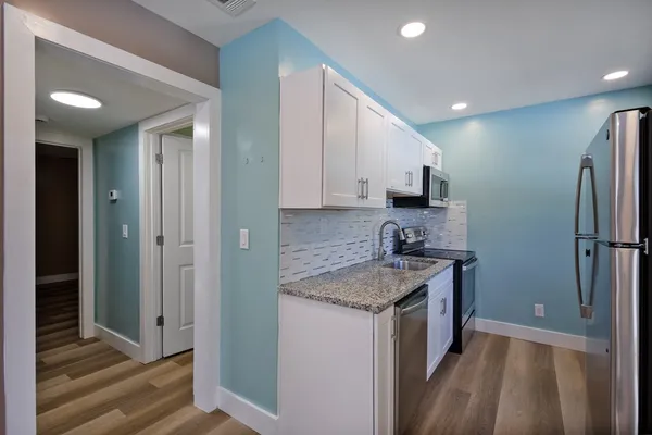 a kitchen with a sink stove and refrigerator