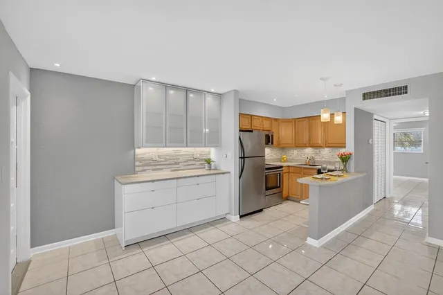 a kitchen with a cabinets and a stove top oven