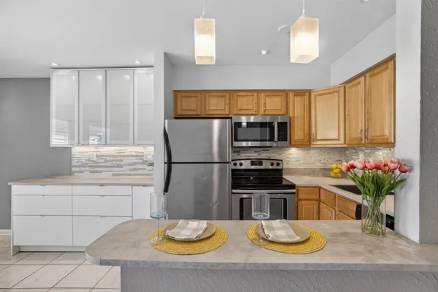 a kitchen with stainless steel appliances a stove and a refrigerator