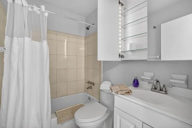a bathroom with a bath tub sink and a shower