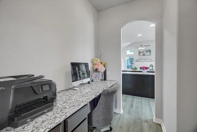 a kitchen with kitchen island a stove and a wooden floors