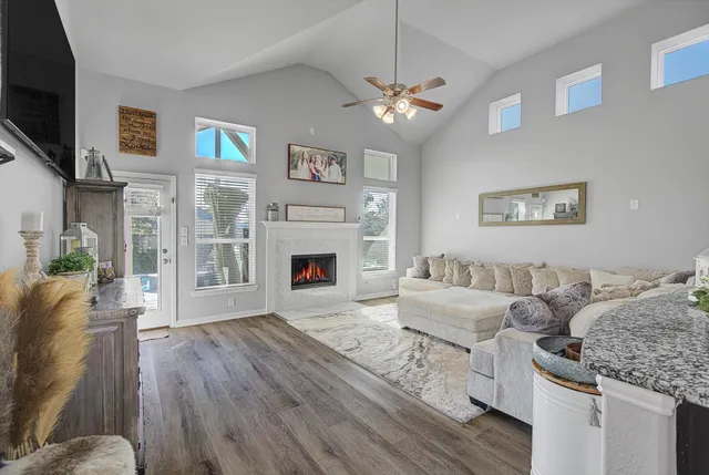 a living room with furniture a fireplace and a flat screen tv