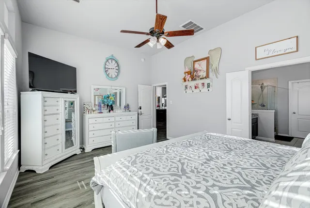 a bedroom with a bed and a flat screen tv