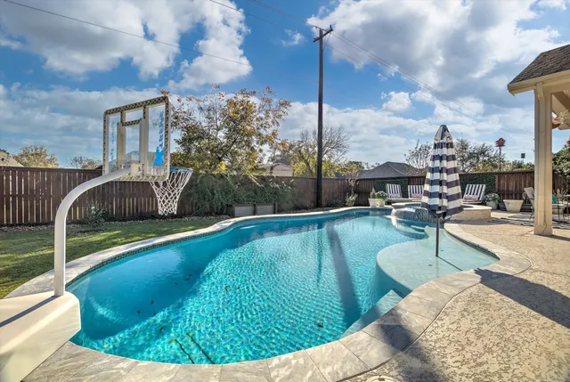 a view of a swimming pool with a patio