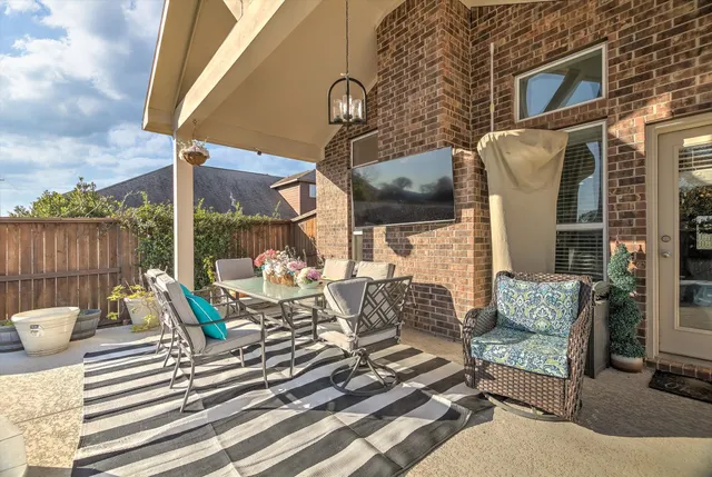 a view of two chairs in the patio