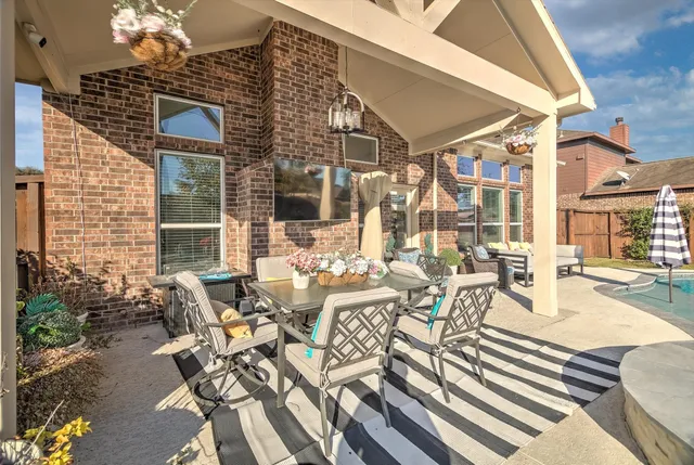 a view of a patio with table and chairs and potted plants