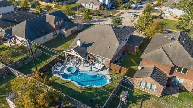 an aerial view of a house with garden space and street view