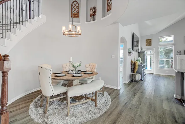 a view of a dining room with furniture and wooden floor
