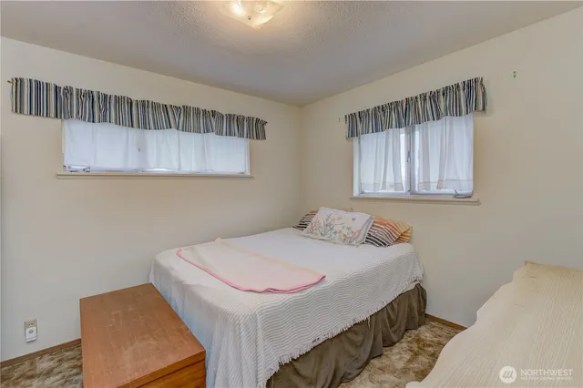 a bedroom with a bed and a window in it