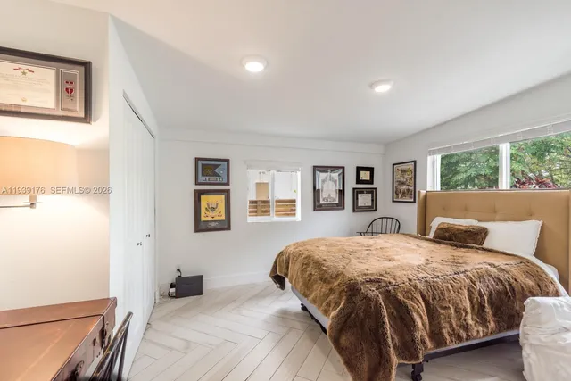 a bedroom with a large bed and a large window