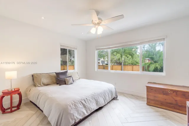 a bedroom with a bed and window