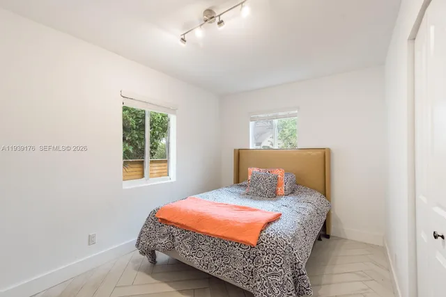 a bedroom with a bed and window