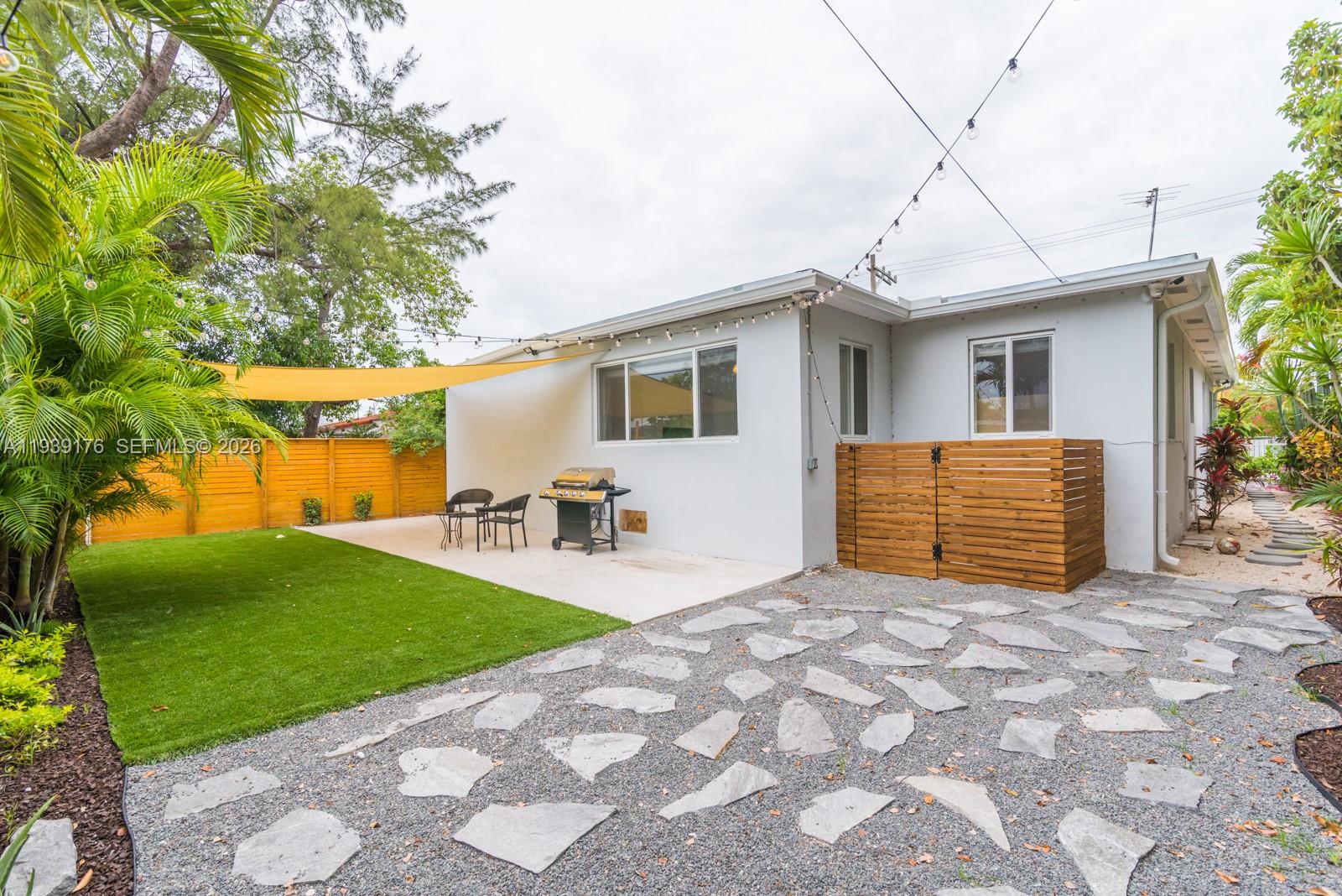 44 Northwest 40th Street Miami, FL 33127 - Photo 22 of 25 a view of a house with backyard and a tree