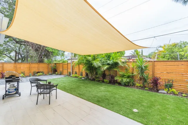 a view of a backyard with sitting area