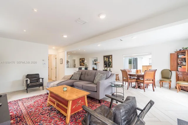 a living room with furniture a table and a flat screen tv