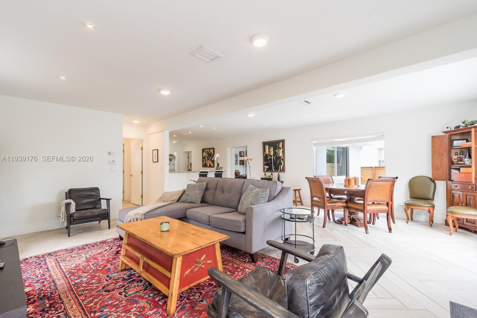44 Northwest 40th Street Miami, FL 33127 - Photo 5 of 25 a living room with furniture a table and a flat screen tv