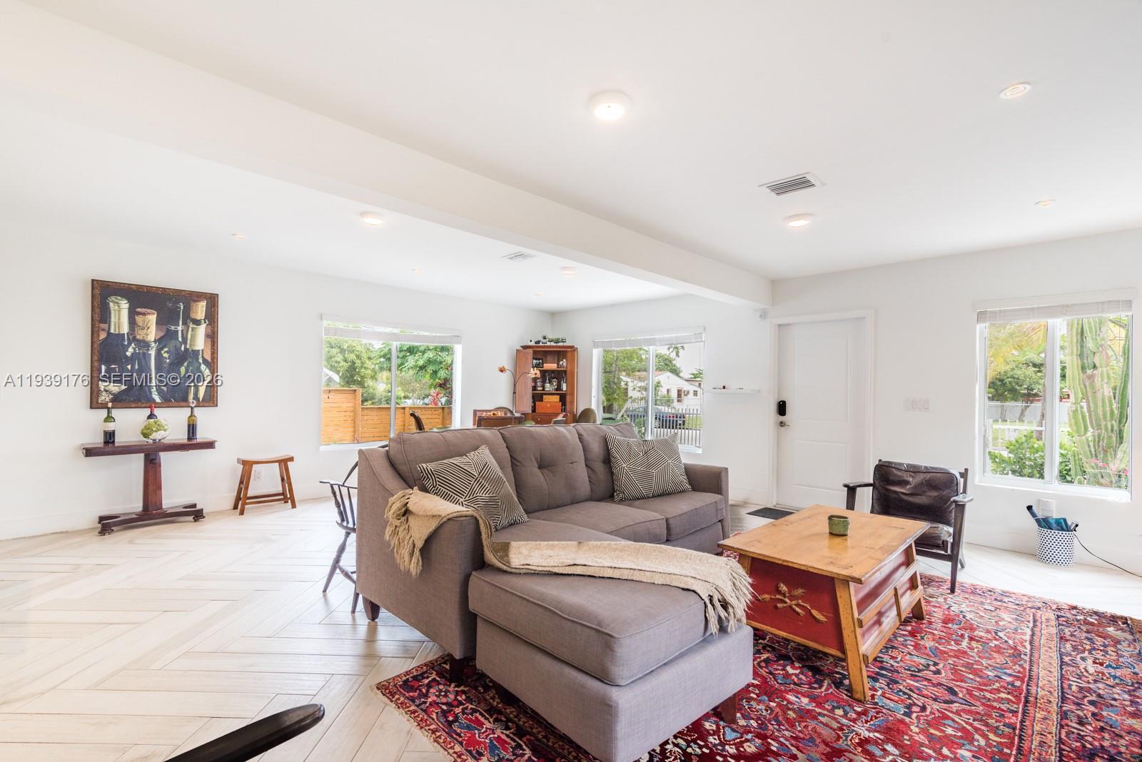 44 Northwest 40th Street Miami, FL 33127 - Photo 6 of 25 a living room with furniture and a large window