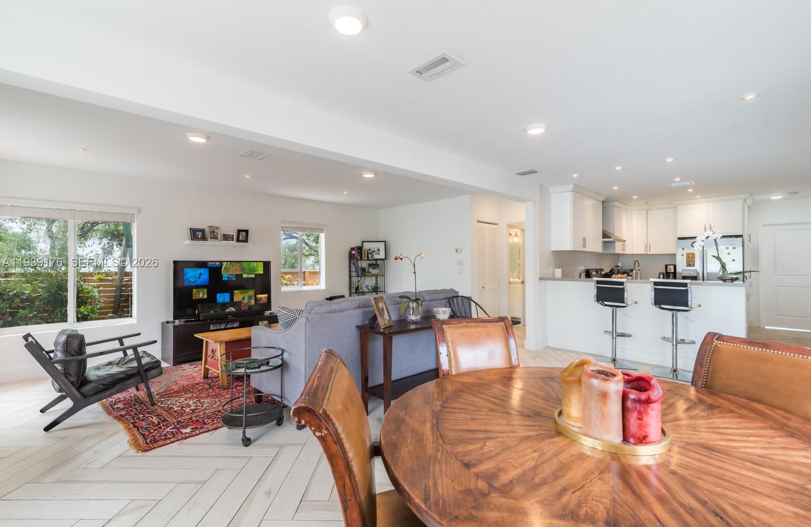 44 Northwest 40th Street Miami, FL 33127 - Photo 7 of 25 a living room with furniture kitchen view and a large window