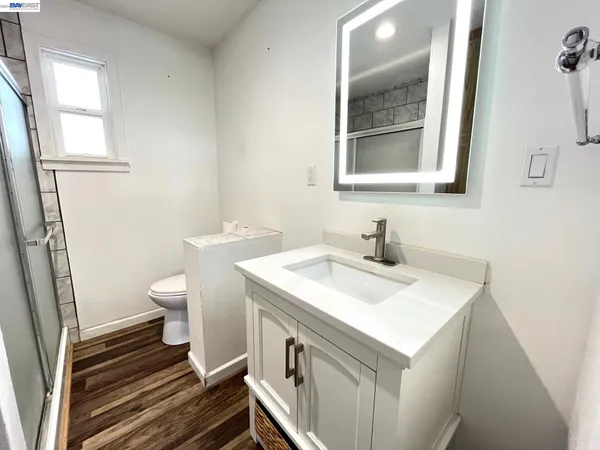 a bathroom with a sink toilet and mirror