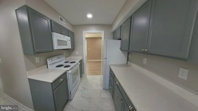 a kitchen with a refrigerator sink and stove