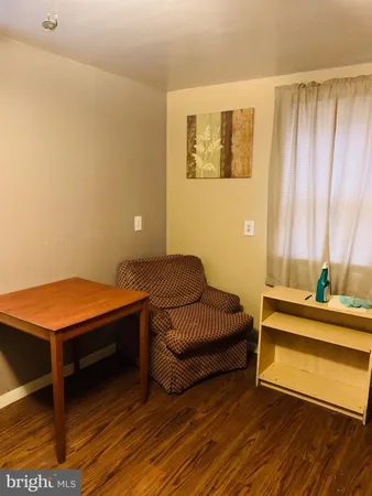 a living room with furniture and a pool table