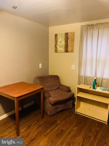 a living room with furniture and a pool table