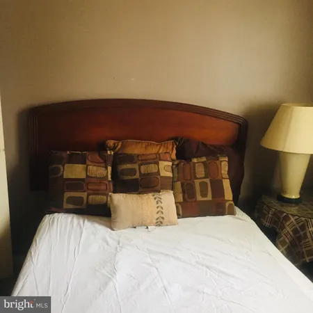 a bedroom with a bed and a chair