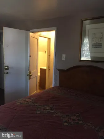 a bedroom with a bed next to a window