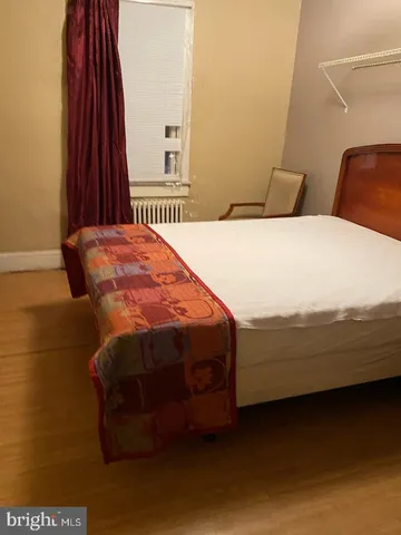 a bedroom with a bed and a closet