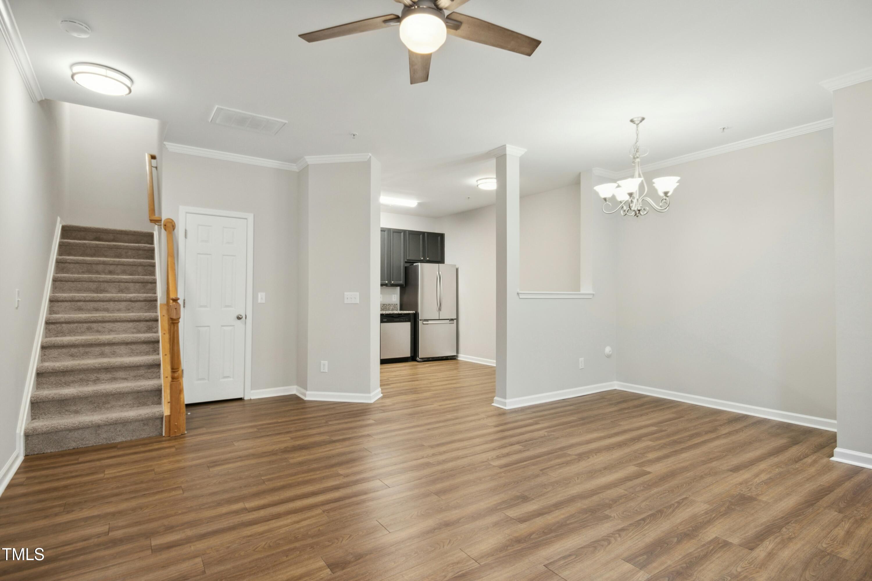 2225 Raven Road, Unit 107 Raleigh, NC 27614 - Photo 13 of 35 a view of an empty room with wooden floor and a ceiling fan