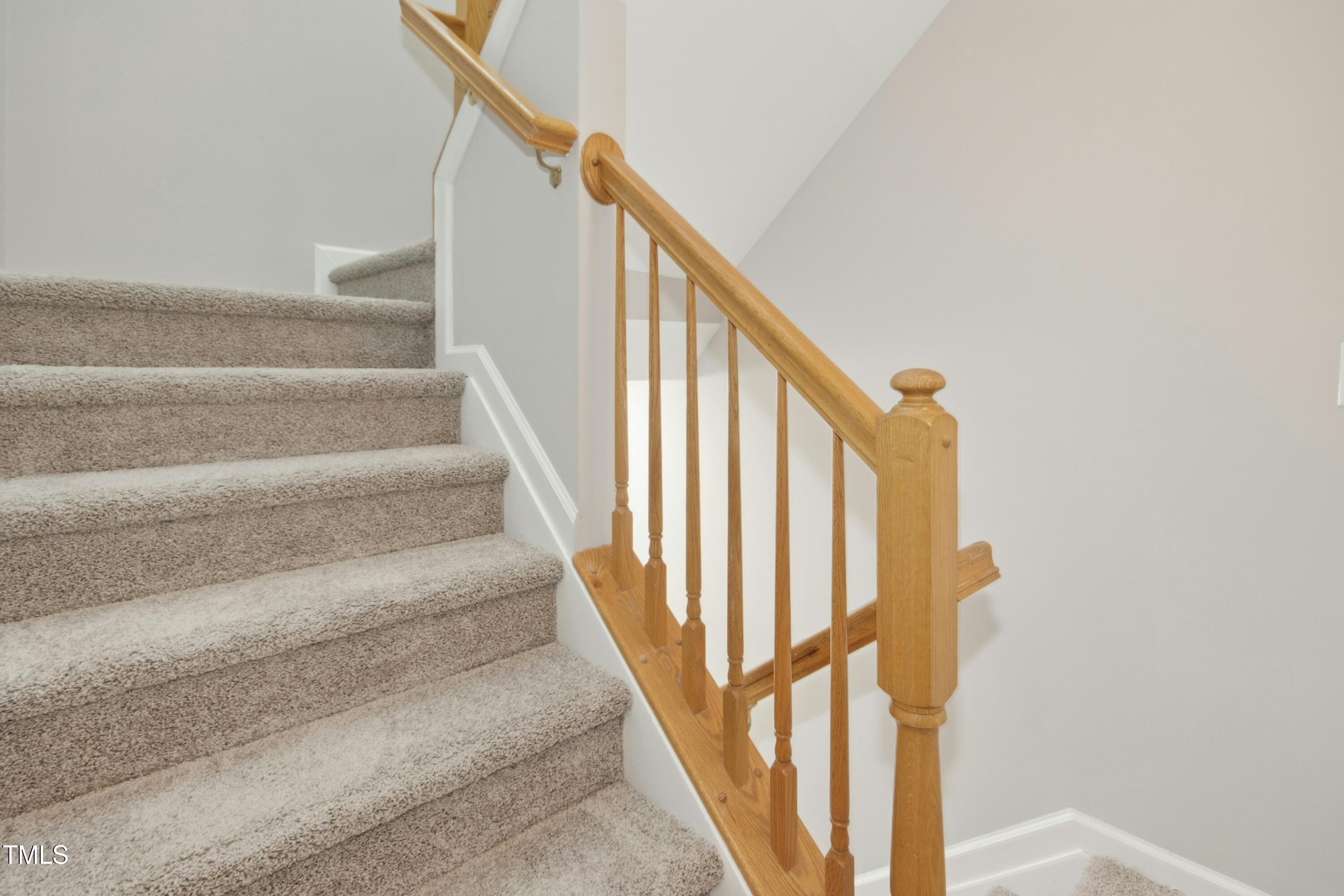 2225 Raven Road, Unit 107 Raleigh, NC 27614 - Photo 14 of 35 a view of staircase with wooden floor and white walls
