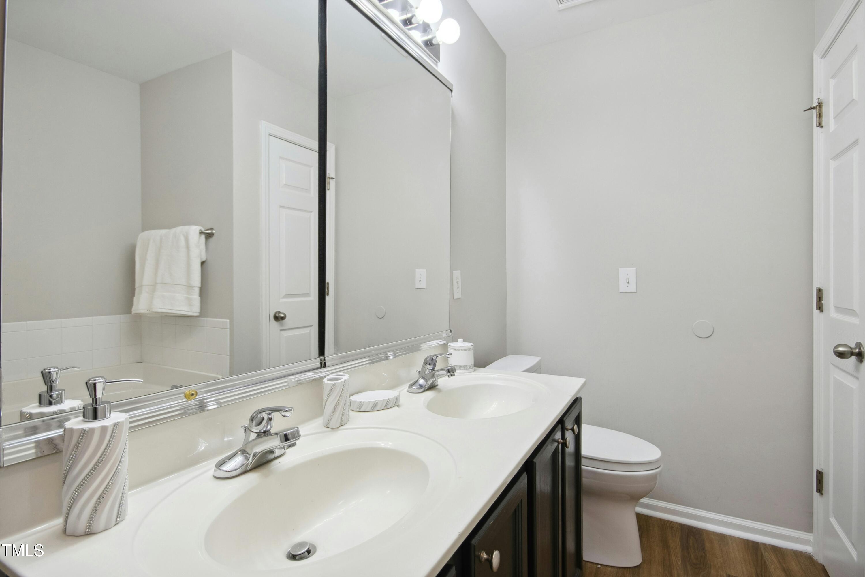 2225 Raven Road, Unit 107 Raleigh, NC 27614 - Photo 30 of 35 a bathroom with a toilet sink and mirror