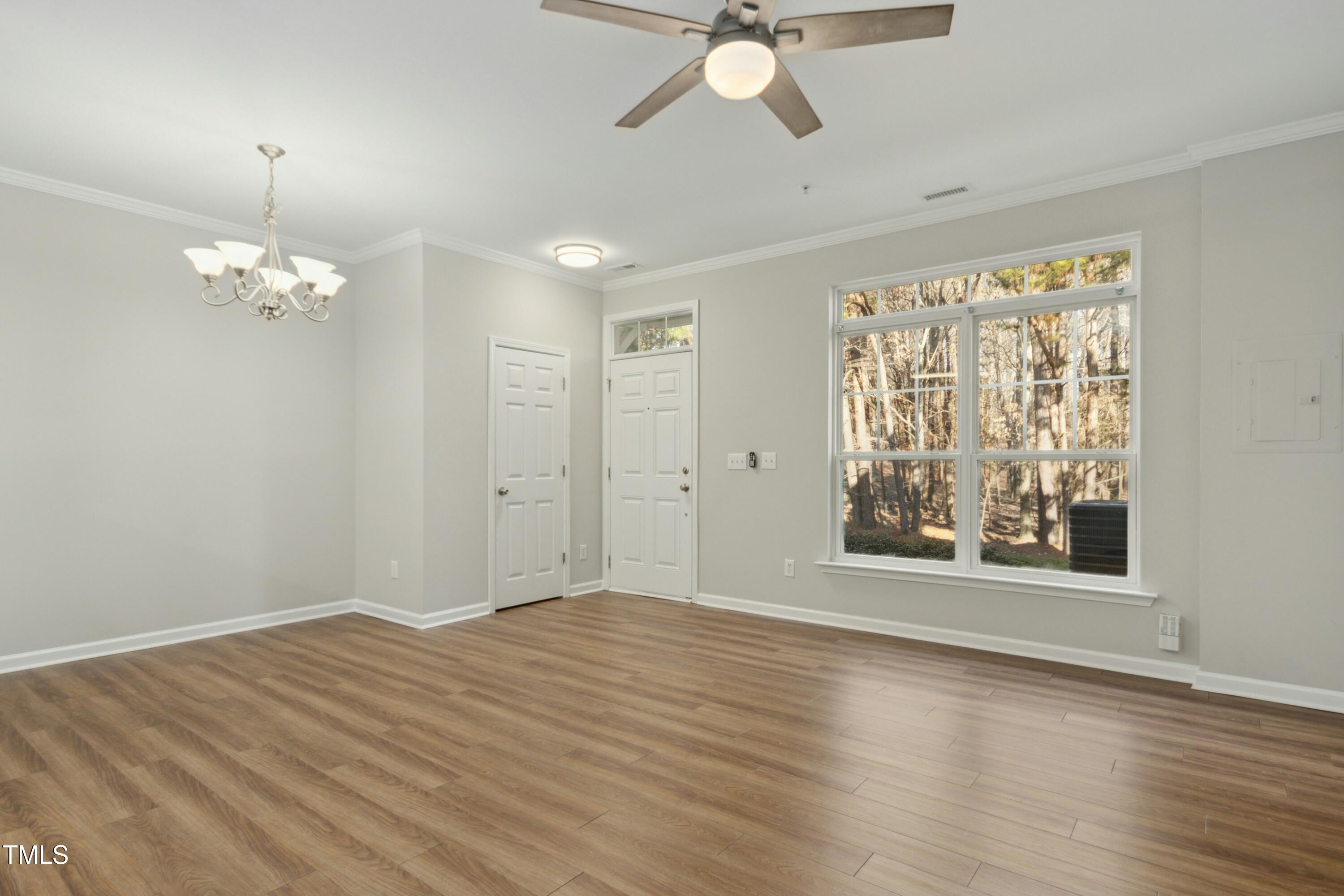 2225 Raven Road, Unit 107 Raleigh, NC 27614 - Photo 6 of 35 a view of an empty room with wooden floor and a window