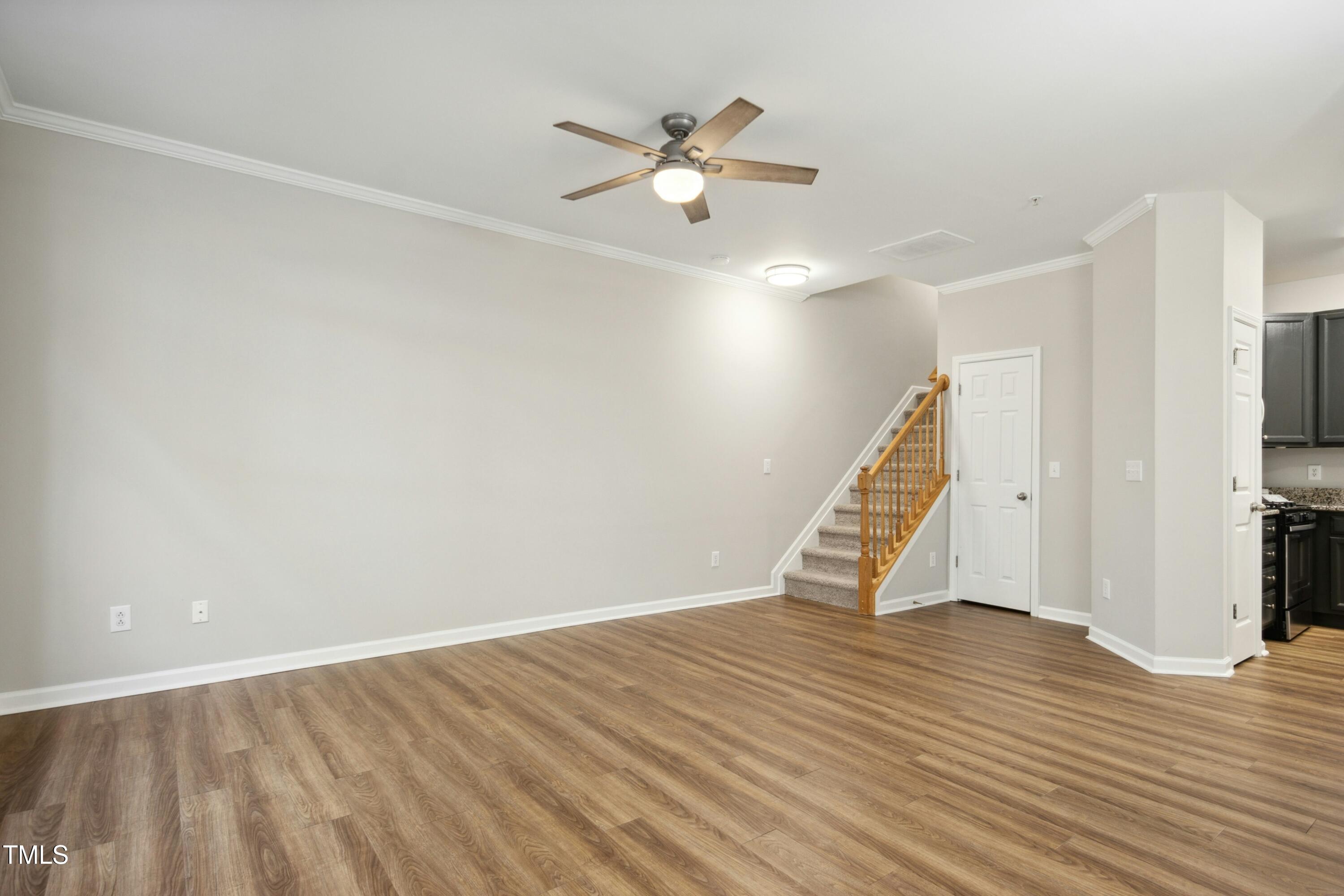 2225 Raven Road, Unit 107 Raleigh, NC 27614 - Photo 8 of 35 a view of an empty room with wooden floor and a ceiling fan