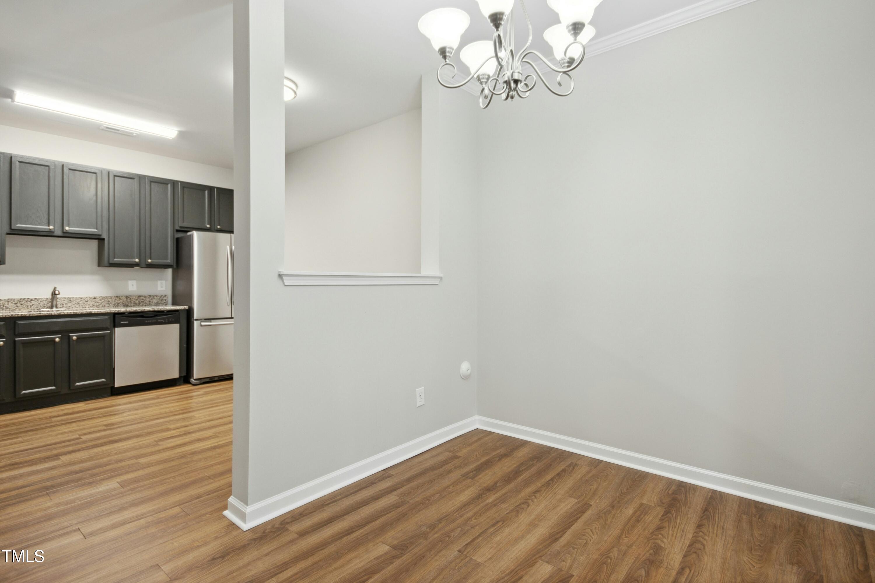 2225 Raven Road, Unit 107 Raleigh, NC 27614 - Photo 9 of 35 a view of a kitchen with a microwave and a stove