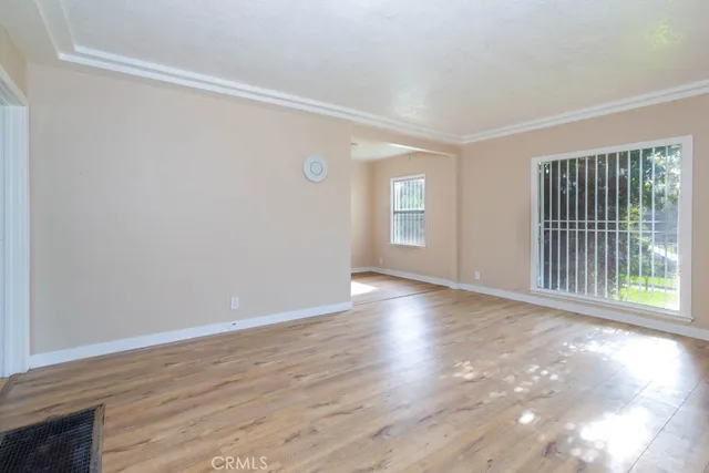 a view of a room with wooden floor and windows
